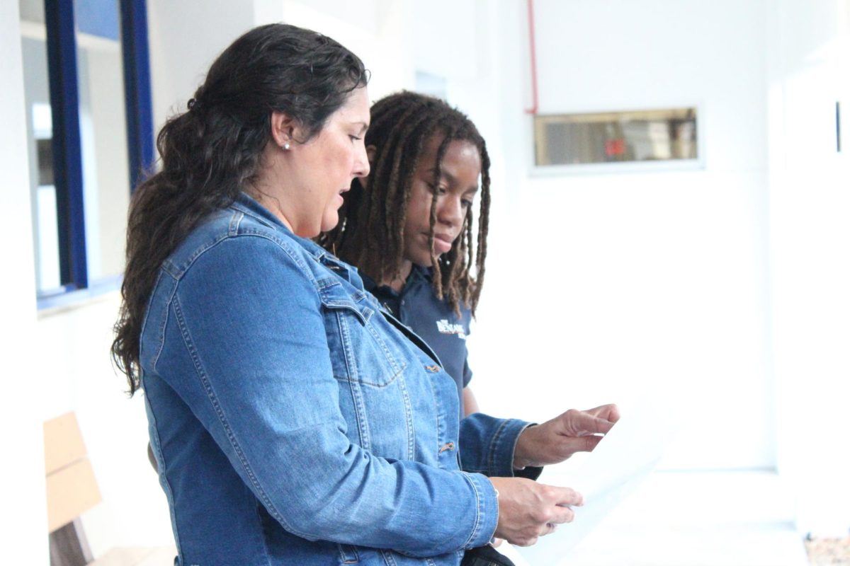 Seventh grader Jace Cosby-Mosley directs a parent towards a classroom