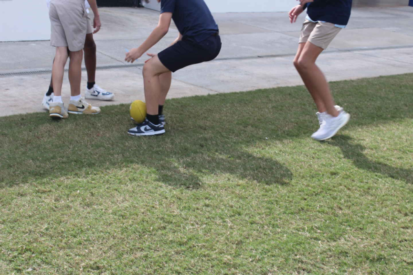 8th Graders Harrison Poulakakous, Blake Smith, Timothy Lovas, and Jahari Chin playing soccer during recess
