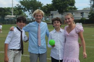 7th graders pose with a spikeball in their professional dress