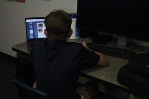 James Wright (8) pulls up his work on his computer